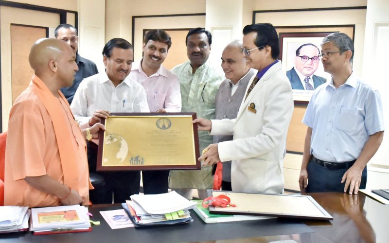 UPCM चतुर्थ अंतरराष्ट्रीय योग दिवस पर कीर्तिमान बनाने वाले सहारनपुर के अधिकारियों को प्रमाण पत्र सौंपाते हुए